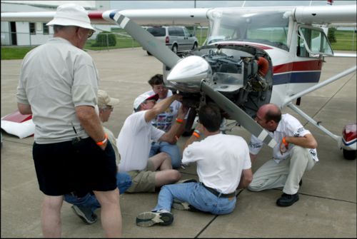Kirk, Charles, Jeff, Matthew, and Wayne, trying to fix the alternator on Wayne's plane. 